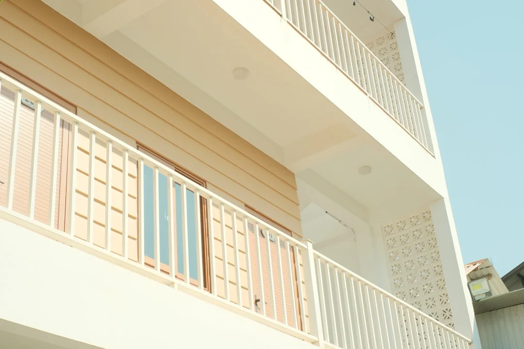Open cardboard box with clothes by window, symbolizing moving or relocation.
